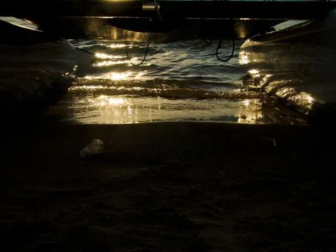 Sunset reflection on water over a sandy beach Stock-Fotos