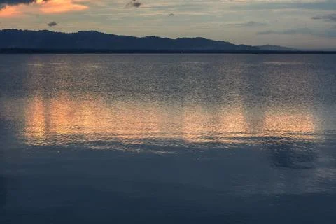 Sunset reflection on water surface Фото