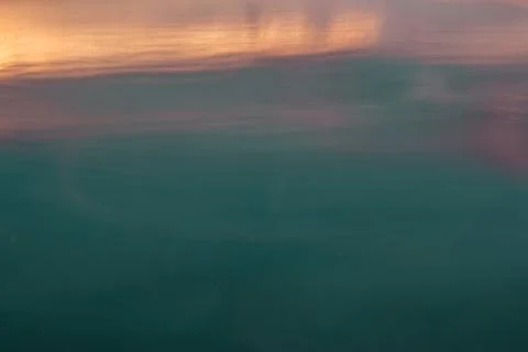 Sunset reflection on water surface Stock Photos