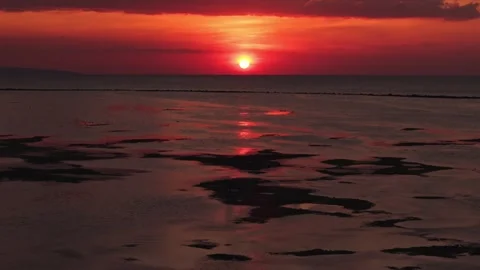 Sunset Reflection on Wet Sand During Low Tide Stock Footage 341679303