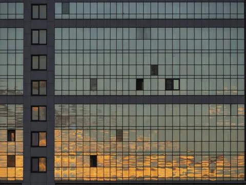 Sunset Reflection in the windows of modern skyscraper Building or apartment Stock Photos