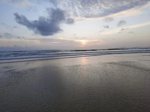 Sunset reflections on the beach. sky reflections on the water. Stock Photos