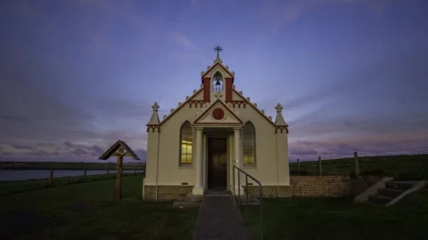 Sunset reflections in the Italian Chapel windows in Orkney HD Time Lapse Video stock 256082857