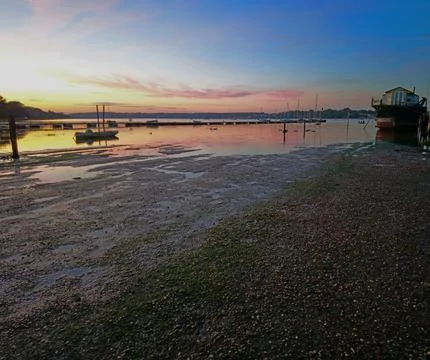 Sunset reflections at low tide on the river Fotos de archivo