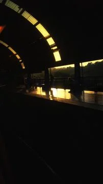 Sunset Reflections on Modern Train Station Platform Stock Photos