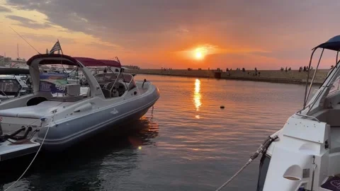 Sunset Reflections Over Calm Harbor with Boat Stock Footage 316218920