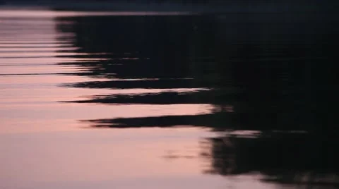 Sunset reflections on the surface of a calm lake Stock Footage 45357474