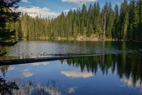 Sunset reflects over surface of Zminje lake in Durmitor National Park, Zabljak Stock Photos