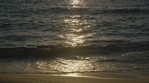 Sunset reflects of the sea waves and beach sand Stock Footage 125213004