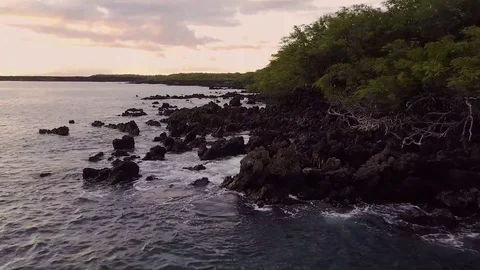Sunset Reveal While Flying Over Waves Crashing On Lava Rocks Video stock 83733737