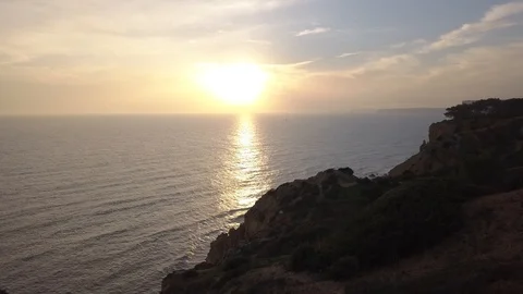 Sunset revealing the beach and cliffs by the Ocean Stock Footage 98369268