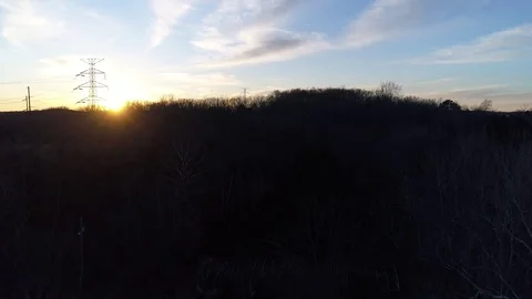Sunset Rising with Power Lines hills and trees Stock Footage