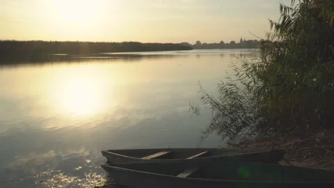 Sunset on the river against the backdrop of wooden boats Stock Footage 140620120