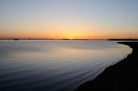 Sunset on a river bank Stock Photos