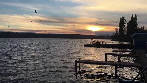 Sunset on the river bank at the pier Stock Footage 70388605