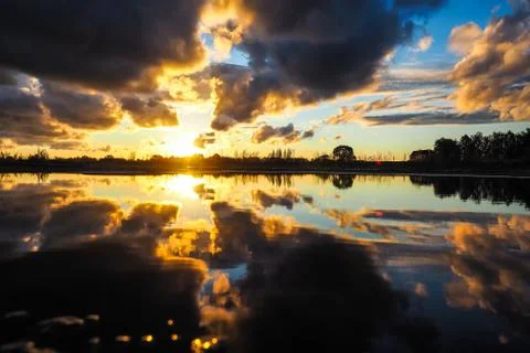 Sunset on the river, beautiful reflection, clouds. Selective focus Foto stock