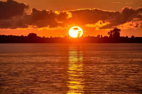 Sunset on the river, big sun Stock Photos