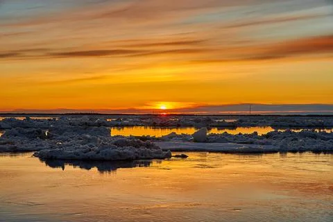 Sunset on the river during an ice drift Stock Illustration