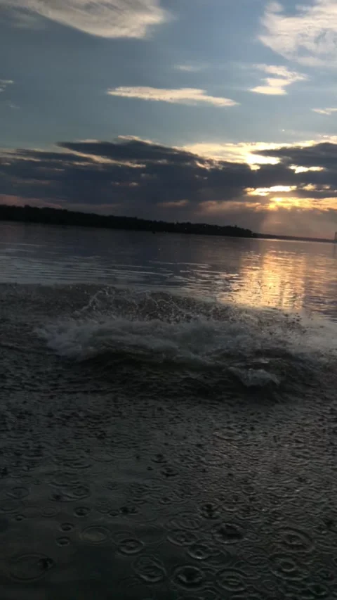Sunset by the river a group of guys jumping together water forming big waves Stock Footage 161559473