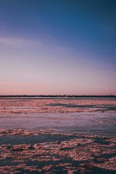 Sunset on the river, ice on the background Stock Photos