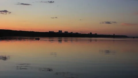 Sunset on the river. A man floating in a rubber boat Stock Footage 135235392
