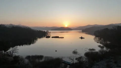 A sunset river with the mountain and trees Video stock 303550936