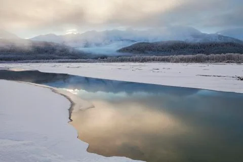 Sunset river reflections with fog Stock Photos