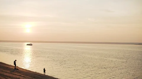 At sunset on the river sailing ship. The riverscape looks boundless and Stock Footage 97205693