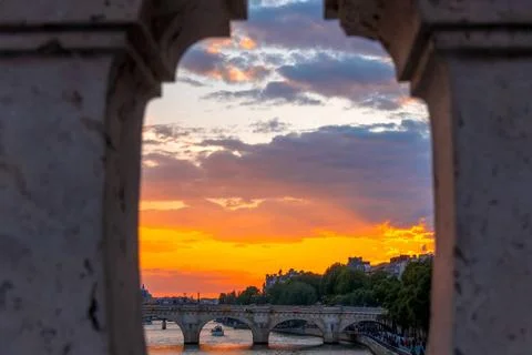 Sunset on the River Seine Through the Granite Fence of the Bridge France. ... Stock Photos