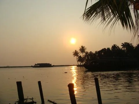 Sunset in River side with Reflection on water Coconut tree area Stock Photos