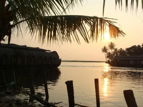 Sunset in River side with Reflection on water Coconut tree area Stock Photos
