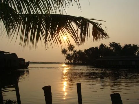 Sunset in River side with Reflection on water Coconut tree area Stock Photos