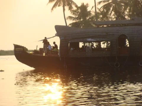 Sunset in River side with Reflection on water some Fishermen on board Stock Photos