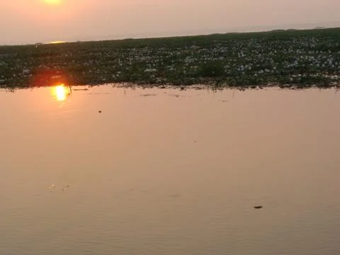 Sunset in River side with Reflection on water beautiful natural beauty Stock Photos