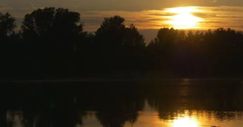 Sunset on The River, Silhouettes of Trees And Sky Reflection in Water Stock Footage 50857464