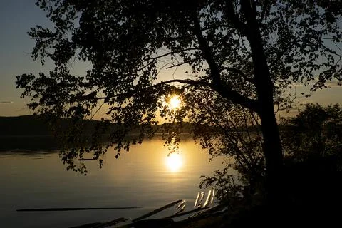 Sunset on the river through the trees Stock Photos