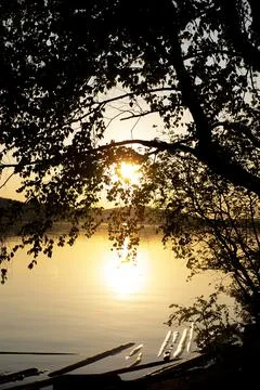 Sunset on the river through the trees Stock Photos