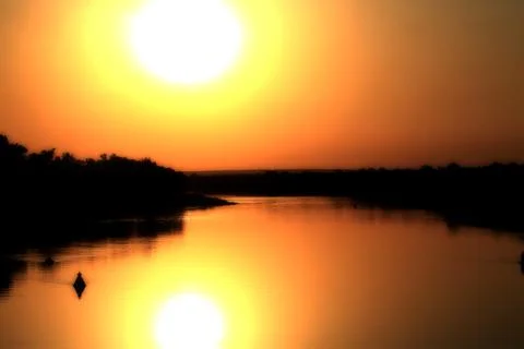 Sunset on the river Twilight Stock Photos