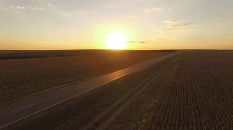 Sunset road with a car Camera moving backwards Stockbeeldmateriaal 68863132