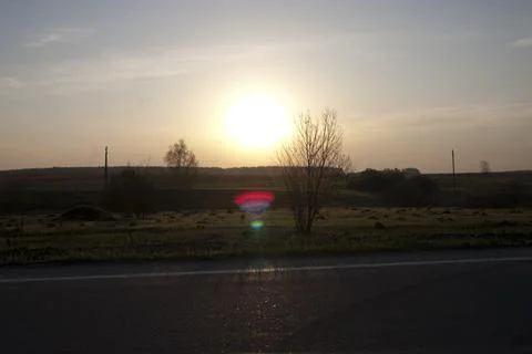 Sunset on the road in the fields of the Russia. Stock Photos