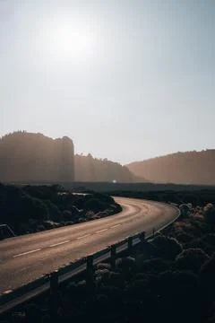 A sunset road with a mountain in the background Fotos de archivo