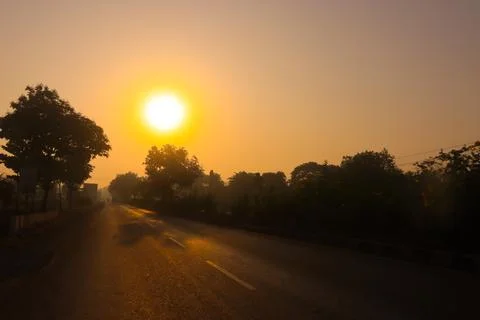Sunset on the road side with trees Stock Photos