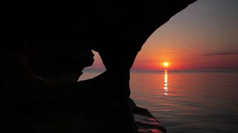 Sunset with rock formation in foreground on lake superior Stock Footage 55013338