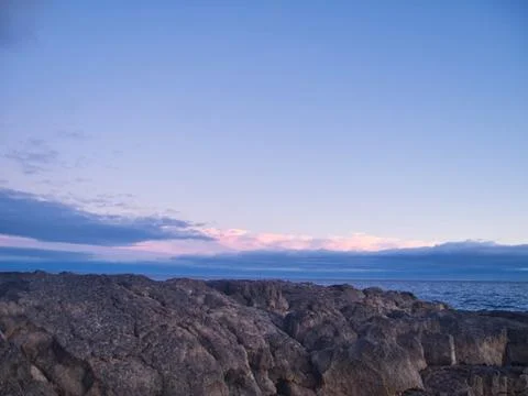 Sunset rocks and a light sky with gentle lights Stock Photos