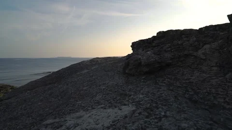 Sunset by the rocks by the sea Stock Footage 167584610