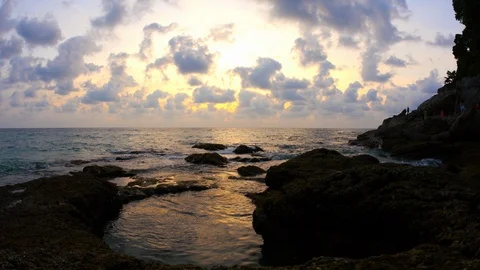 Sunset on the rocks of Surin beach, Phuket, Thailand Stock Footage 110755193