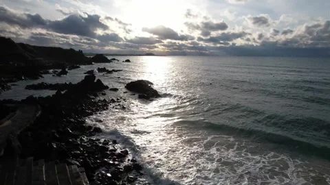 Sunset on the rocky beach with clouds 動画素材 310345151