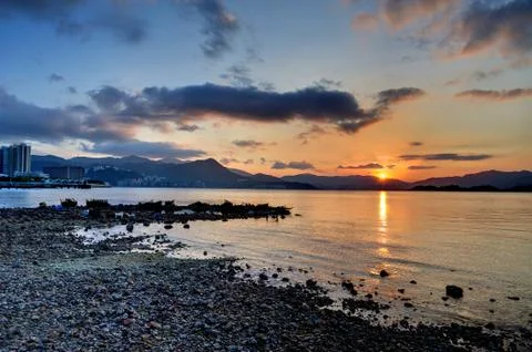 Sunset rocky beach Stock Photos