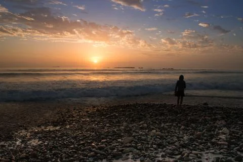 Sunset on rocky beach Stock Photos