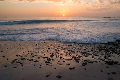 Sunset on rocky beach Stock Photos
